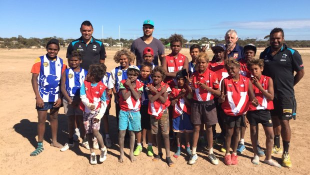 Giving back: Port Adelaide ruckman Paddy Ryder (centre) with Paul Vandenbergh (left), Byron Pickett (right) and kids at Yalata. 