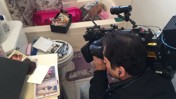 Journalists film inside the flat of Syed Farook and Tashfeen Malik in Redlands, California.