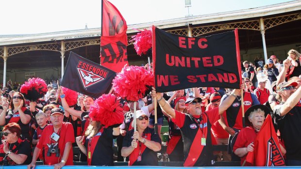 Don worry, be happy: Essendon supporters celebrate victory over Carlton last month.