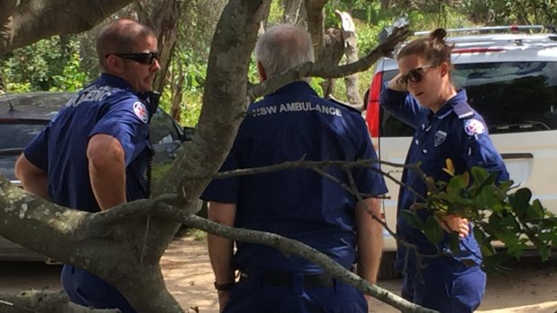 Ambulance workers attend the search for a boy swept out to sea at Port Macquarie last week.