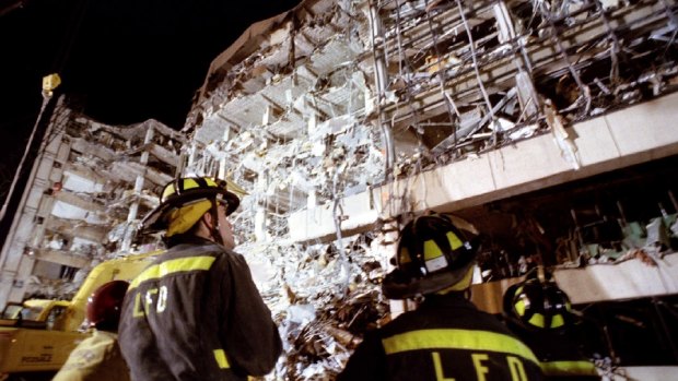 Fire fighters examine the wreckage of the Alfred P. Murrah Federal Building after a truck bomb destroyed the north side of the building in downtown Oklahoma City on April 19, 1995.