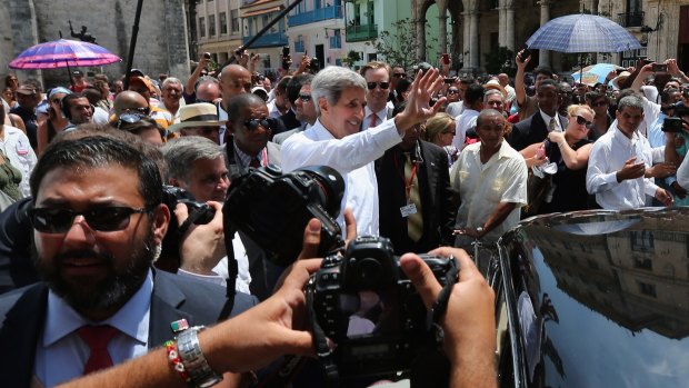 US Secretary of State John Kerry surrounded by a wall of Cuban and American security agents as he walks through Havana.