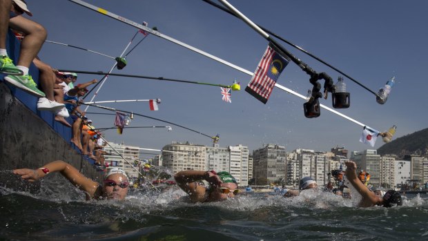 Competitors swim past the feeding station during the women's marathon swimming event off Copacabana Beach in Rio on Monday.
