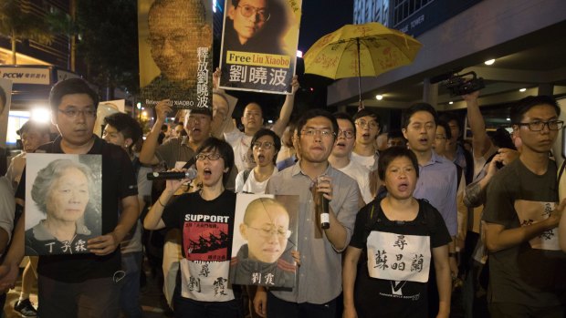 Demonstrators march towards the hotel where the Chinese President Xi Jinping is staying in Hong Kong. China is marking the the 20th anniversary of Beijing taking control of the former British colony.