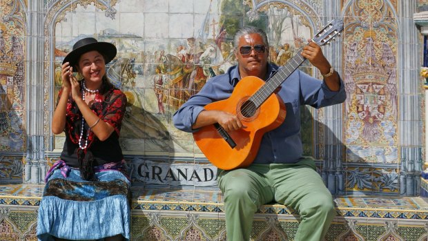 Flamenco musicians performing in the Granada alcove of the Plaza de Espana, Seville, Spain. 