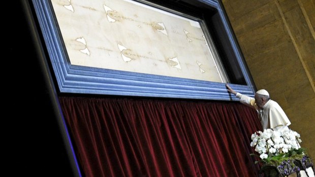 Pope Francis touches the Shroud of Turin during a two-day pastoral visit in Turin, Italy.