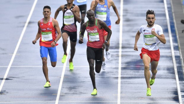  Kenyan sprinting coach John Anzrah was accused of carrying the accreditation of Ferguson Rotich, centre. 