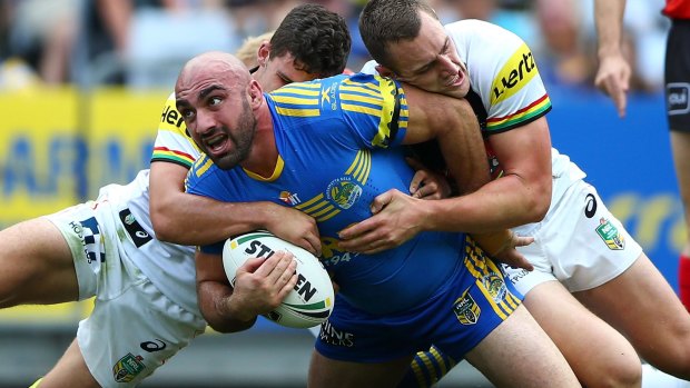 Leading from the front: Tim Mannah is wrapped up.