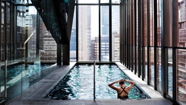 Through floor-length windows you can glimpse the pool where swimmers seem to glide between the skyscrapers. 