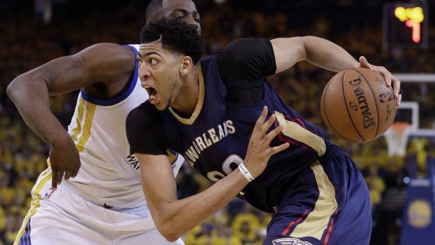On the drive: New Orleans Pelicans forward Anthony Davis gets past Golden State Warriors counterpart Draymond Green.