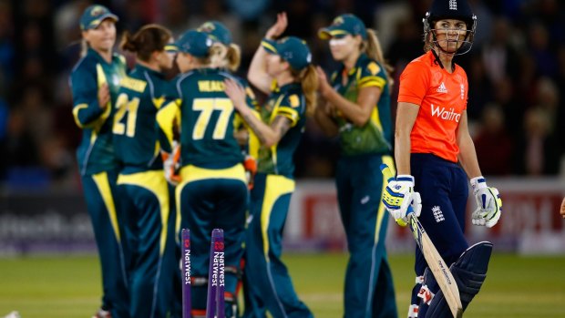 Charlotte Edwards of England walks off after losing her wicket.