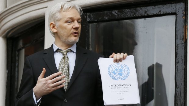 Julian Assange holds the UN report saying the WikiLeaks founder has been been "arbitrarily detained" by Britain and Sweden since December 2010.
