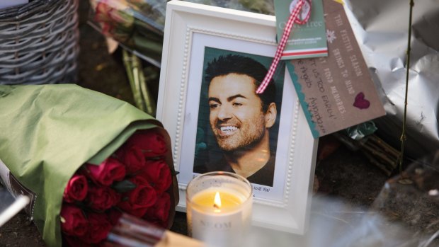 A photograph and floral tributes are left outside the Oxfordshire home of the singer.