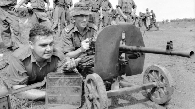 Jack Kirby (left), and Harry Smith test-fire a Goryunov SG43 7.62 x 54mmR Soviet-made Chinese communist heavy machinegun captured at Long Tan. 