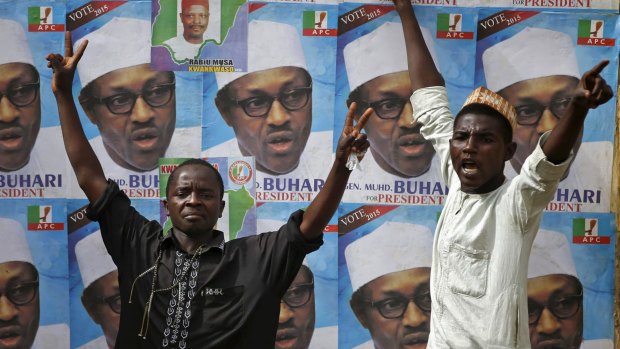Stance against Boko Haram: Supporters of presidential candidate Muhammadu Buhari  in front of his election posters in Kano.