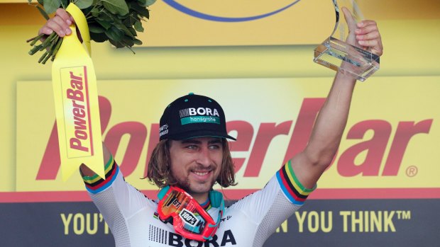Stage winner Peter Sagan of Slovakia celebrates on the podium after the third stage of the Tour de France.
