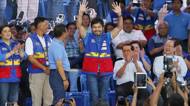 Filipino boxer and congressman Manny Pacquiao is introduced as a senatorial candidate by Philippine Vice-president and now opposition presidential candidate Jejomar Binay, third from left, at the start of the official campaign period for the 2016 presidential elections in Manila, Philippines, last week.
