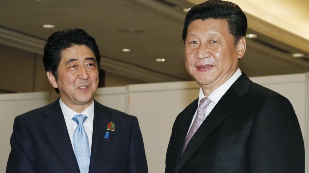 Chinese President Xi Jinping, right, shakes hands with Japanese Prime Minister Shinzo Abe in Jakarta in April. 