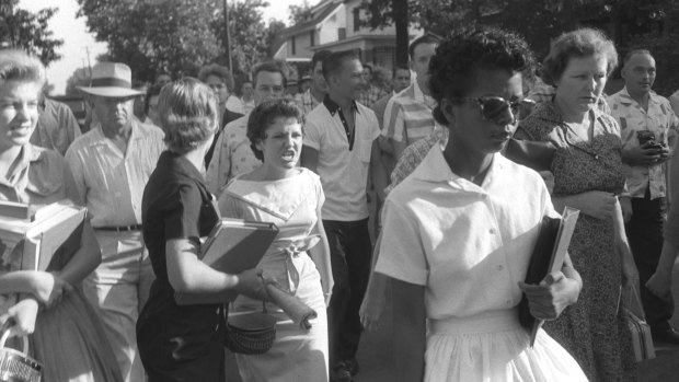 Hazel Bryan, centre, her face twisted in anger, is part of the crowd taunting Elizabeth Eckford, right foreground, as she walks in front of Central High School in Little Rock on Sept. 4, 1957. National Guardsmen who blocked the main entrance wouldnot let Eckford enter. She was the first to try to break the school's color barrier. Eight others later were also turned away. 
