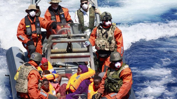 Pregnant Somali refugee, Rahma Abukar Ali (centre), in a German Navy boat in the Mediterranean Sea, near Italy.  