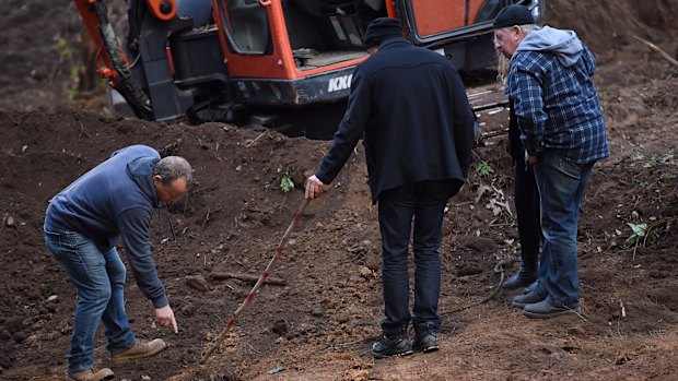 Detectives show Mark and Faye Leveson where they found bones.