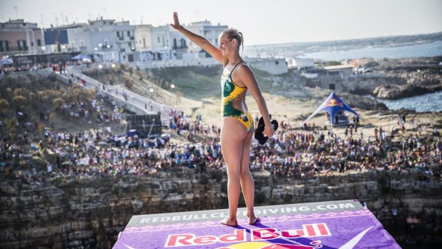Rhiaannan Iffland waves to her parents before diving from the 21.5-metre platform during the Red Bull Cliff Diving World Series in Polignano a Mare, Italy.  