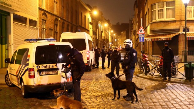 Police officers guard a road after raids in which several people, including Paris attacks suspect Salah Abdeslam, were arrested in Sint-Jans-Molenbeek last week.