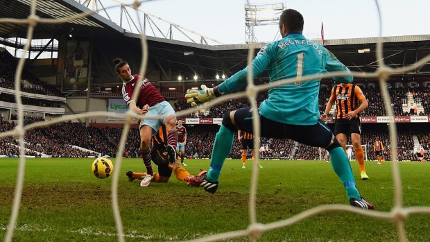 West Ham's Andy Carroll shoots past Hull goalkeeper Allan McGregor at Upton Park on Sunday.