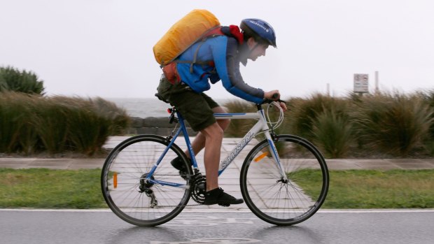 Just get through it: A cyclist rides into a strong head wind in Port Melbourne on Sunday.