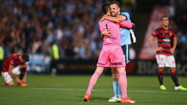 Winning embrace: Vedran Janjetovic and Matt Jurman celebrate Sydney FC's victory over the Wanderers last month.
