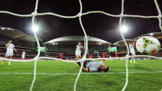 Beaten: Jamie Young of Brisbane looks on as Adelaide scores in their A-League preliminary final on Friday.