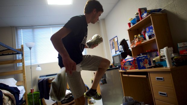 Crosby Gardner puts away groceries in his Western Kentucky University dorm room.