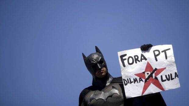 A demonstrator, dressed as Batman, calls for President Dilma Rousseff's  government to be dismissed.
