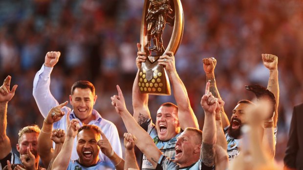 Long time in the making: Paul Gallen holds aloft the NRL premiership trophy. 