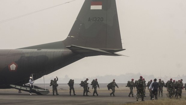 Indonesian soldiers are deployed to help containing massive forest and land fires that have caused widespread haze.