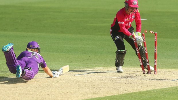 Blown away: Alyssa Healy of the Sixers runs out Heather Knight of the Hurricanes in their semi-final clash at the Gabba. 