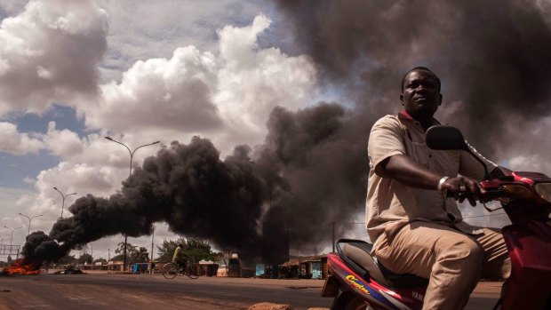 Tires burn as people continue to protest against the military coup in Ougadougou.