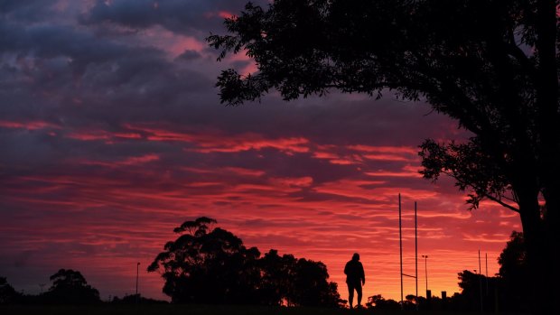 Sydney's red dawn on Monday ahead of some relatively rare winter rain.