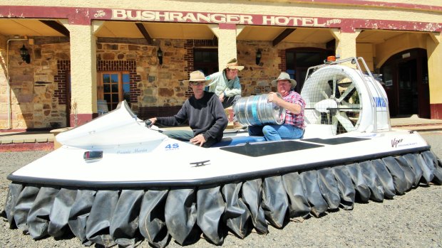 Tim helps Michael Nell and farmer Gary Poile load-up with vital supplies outside the Bushranger Hotel in Collector.