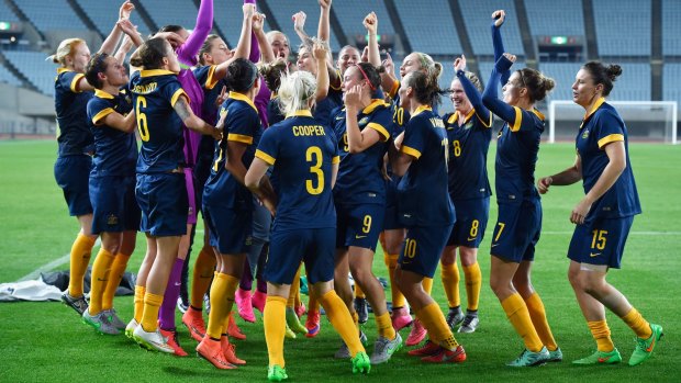 Made it: The Matildas players celebrate after qualifying for the Rio Olympics.