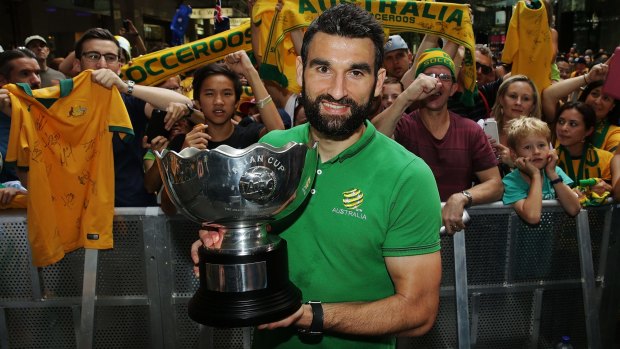 Proud achievement: Socceroos captain Mile Jedinak poses with the Asian Cup during celebrations at Westfield Sydney on Sunday.