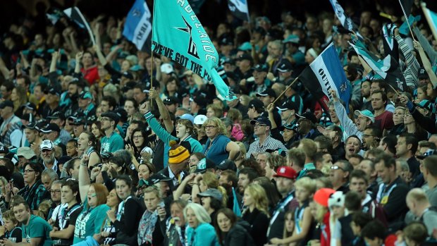 Fans enjoy the atmosphere during a game between Port Adelaide and Hawthorn at Adelaide Oval last season.