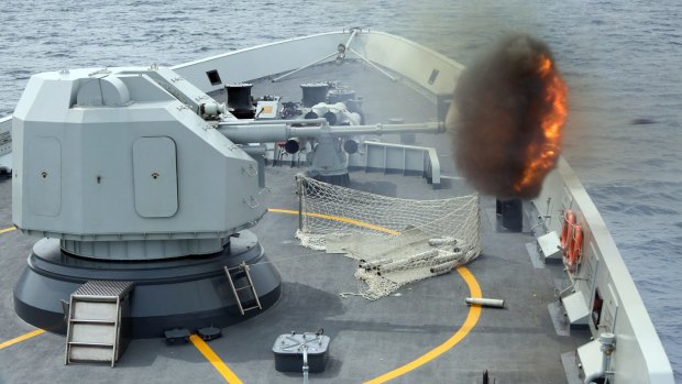 An anti-surface gunnery is fired from a Chinese missile frigate during military exercises by Singapore and Chinese navies in the South China Sea. 