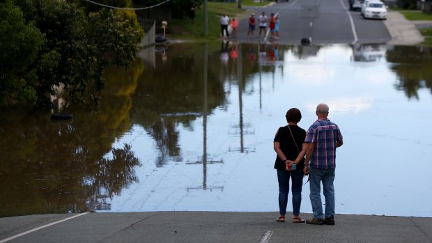 Residents watch flood waters rise in Beenleigh.