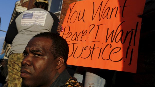 West Baltimore residents  demonstrate against police brutality on Saturday.