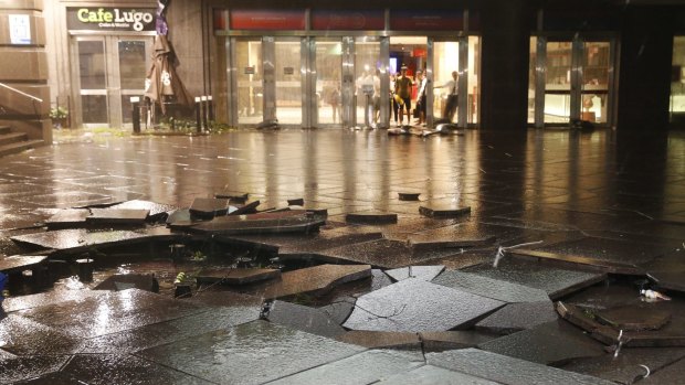 Typhoon Dujuan leaves a trail of damage, including broken tiles at the entrance to a shopping mall in Taipei.
