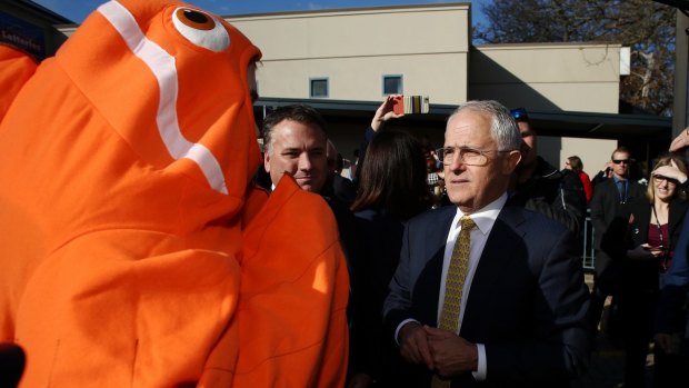 Prime Minister Malcolm Turnbull defended his government's record on the Great Barrier Reef to the protesting fish, Nemo, during a street walk with local MP Jamie Briggs in Adelaide on Friday.