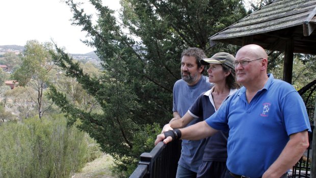Peter Lindbeck, right, and  Peter Kontis and Claire Cooper look over the Queanbeyan River corridor where the Ellerton Drive Extension is proposed.