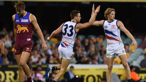 Crows Brodie Smith and Rory Sloane high-five after a goal.