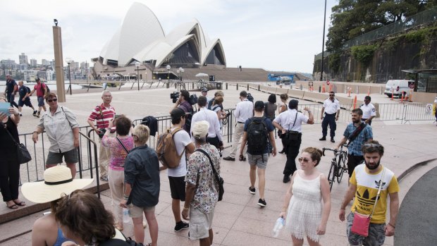 Tourists mill around, unable to access the Sydney Opera House.